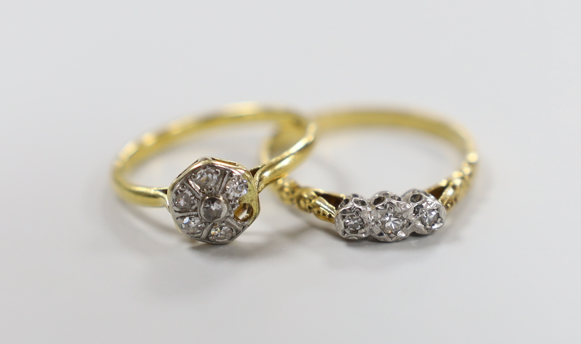 Two 18ct and diamond set rings including illusion set three stone and cluster(stone missing), gross weight 4.4 grams.